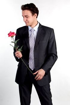 Portrait of a young successful businessman with a flower in your hand
