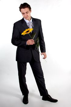 Portrait of a young successful businessman with a flower in your hand