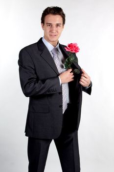 Portrait of a young successful businessman with a flower in your hand