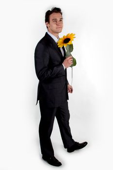 Portrait of a young successful businessman with a flower in your hand