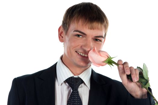 Portrait of a young successful businessman with a flower in your hand