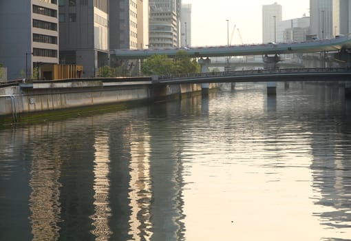 Osaka, Japan - view of famous city in the region Kansai. Sunset light and Kyu-Yodo river.