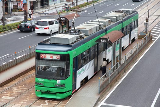 HIROSHIMA, JAPAN - APRIL 21: Public Hiroden tram on April 21, 2012 in Hiroshima, Japan. The tram line recently celebrated its 100th anniversary on May 11, 2012.