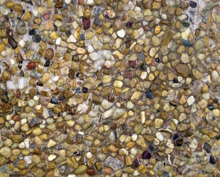 coating of colored pebbles wet with sea water