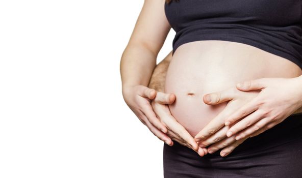Closeup of pregnant woman touching her belly with hands and her husband too, isolated on white background