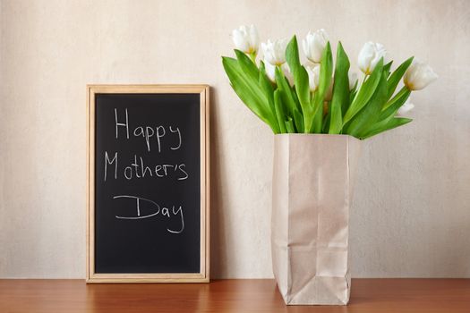 white tulips with Mother's Day greetings, selective focus