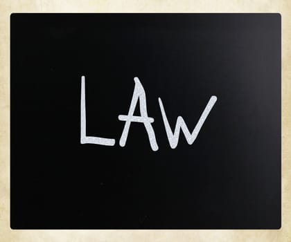 "Law" handwritten with white chalk on a blackboard