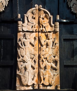 this is a wooden carving door It's have a brown and black colours