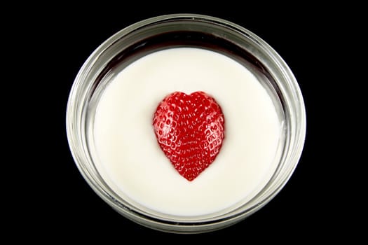 bowl of yogurt with strawberry heart shaped black background