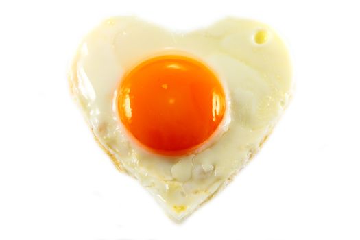 fried egg with heart shape on white background Horizontal