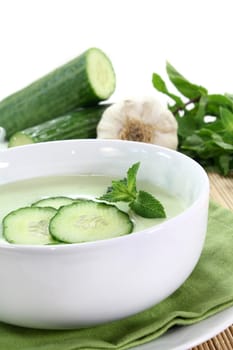 cold cucumber soup with slices of cucumber and mint