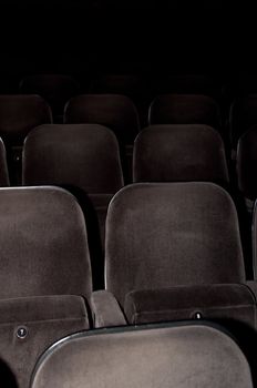 Empty chairs at cinema or theater. Gray toned