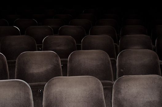Empty chairs at cinema or theater. Gray toned