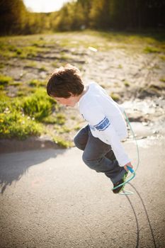 Cute little boy playing jump rope