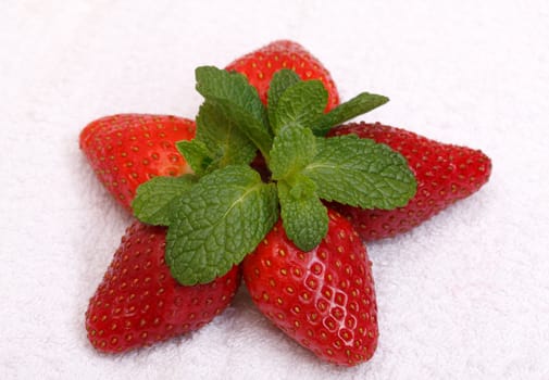 Strawberries with mint over white background