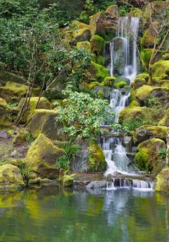 Long Garden Waterfall over moss covered boulders and green vegetation