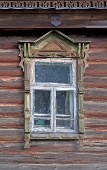 Dirty window in old abandoned wooden house