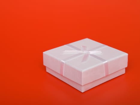 gift box with ribbons, on  red background  