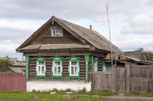 Old wooden country house with carved windows, Russia