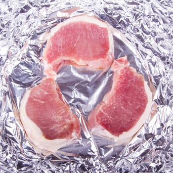 Raw fresh meat in foil for baking