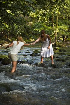 Two Girls In White Crossing The Cold Stream