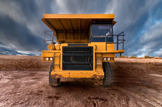 Huge auto-dump yellow mining truck 