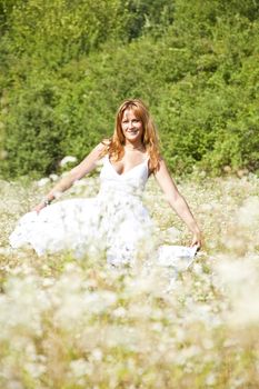 Woman In White Dress Dancing In Nature