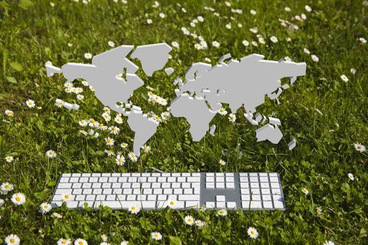 and modern keyboard on green grass in garden