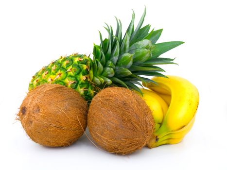 ripe pineapple, bunch of bananas and coconut on a white background 
