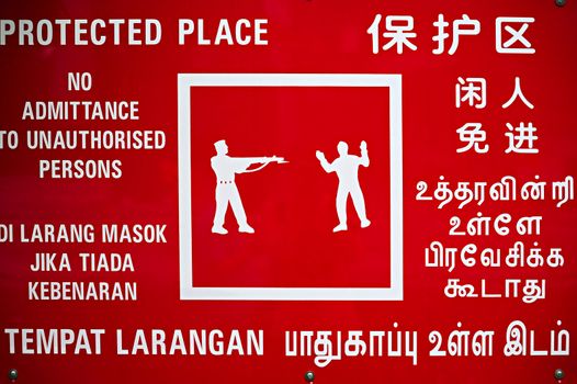 Multilanguage warning sign at Singapore industrial site