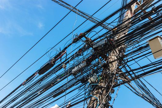 Intertwining of many electrical wires on poles