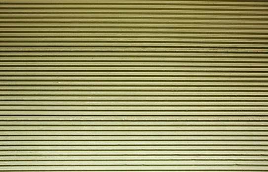 Horizontal corrugated steel wall with a green tint