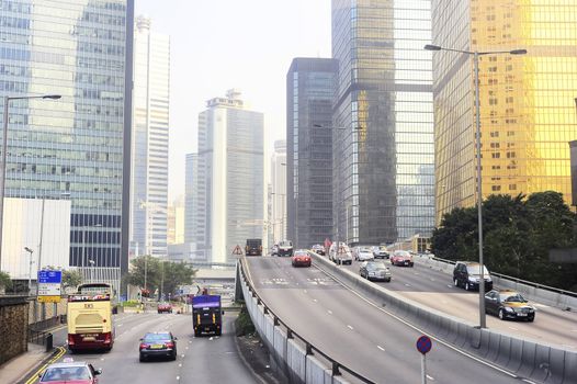 Hong Kong -  January 17, 2013: Many cars on the road at financial center of Hong Kong. Hong Kong is an international financial center, which consists of 112 buildings,standing higher than 180 meters