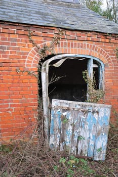 Deserted farm building with wooden door