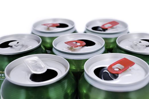 seven open beer cans on a white background