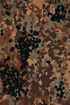 Close up camouflage fabric in a vertical orientation