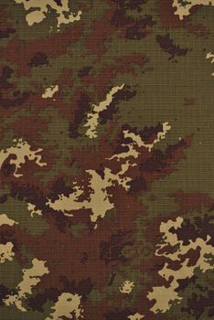 Close up camouflage fabric in a vertical orientation