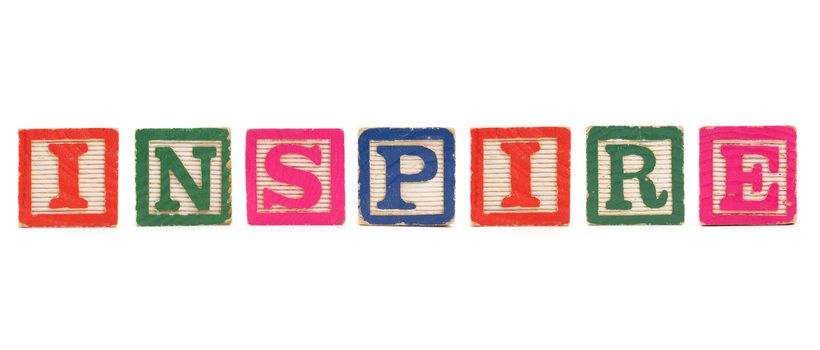The word "INSPIRE" created with children's blocks