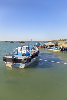 Vertical capture of fishing boats moored at Bet Dwark pier late afternoon at Bet Dwarka in Gujarat India