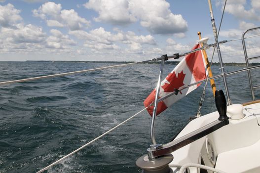 Canadian Flag flying on a moving sailboat