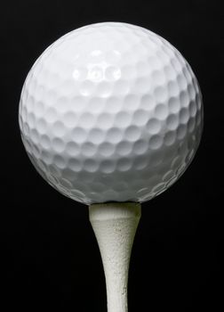 Golf Ball on tee with black background