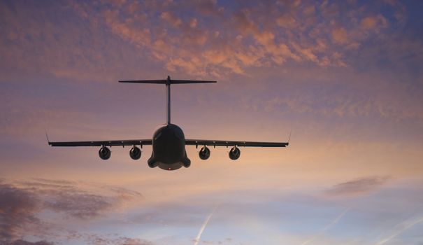 Military transport plane towards the brilliant sunset