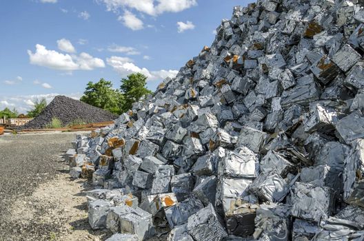 Scrapheap with piles of metal waste ready to be recycled.