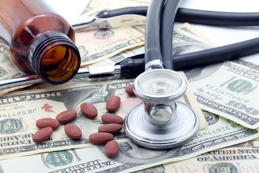 Medical Stethoscope and Pills on Dollars
