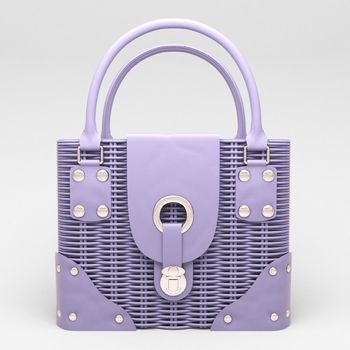 Women's lilac wicker handbag closeup on light background