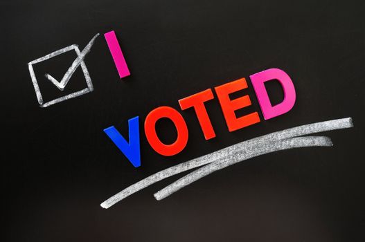 I voted - text made of colorful letters on a blackboard