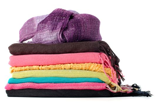 Pile of colorful scarves over white background.