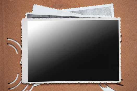 Blank photo frame on a stack of old photos. Clipping path included for eassy issolation