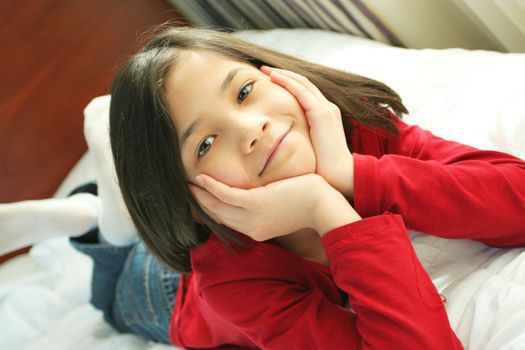 Child lying on bed thinking