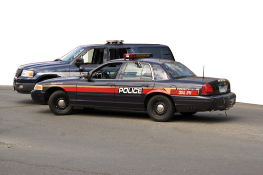 A police car and sport utility vehicle parked in front of a white background.  The clipping path for the white area is included.